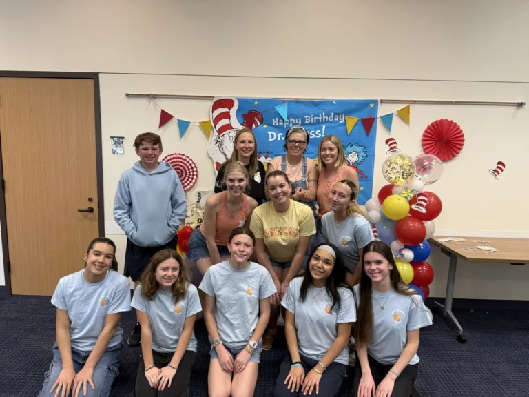Orange Blossoms and Assisteens volunteers working together at a community event