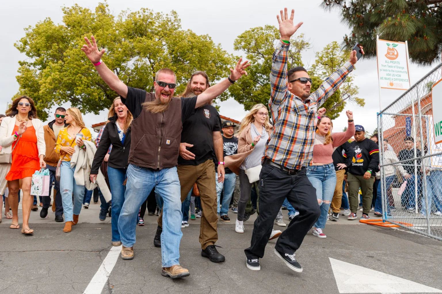 Guests cheering as they enter the Taste of Orange 2025 food, beer and wine festival in Orange, CA