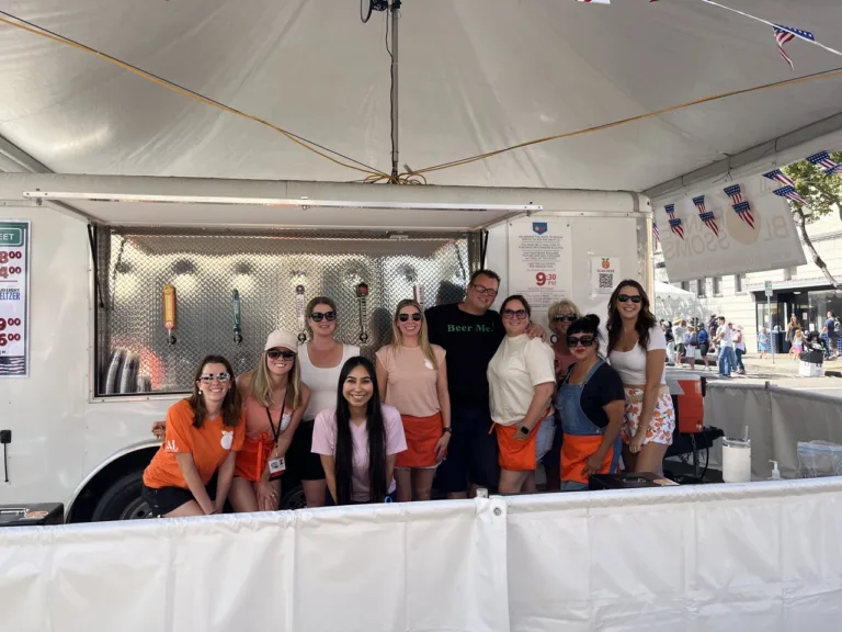 Orange Blossoms and Assisteens volunteers at the Orange International Street Fair 2025