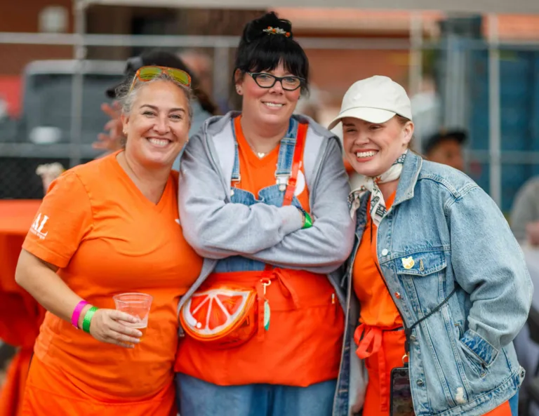 Orange Blossoms members in orange shirts volunteering at Taste of Orange