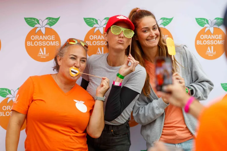Two Orange Blossoms volunteers greeting guests at Taste of Orange